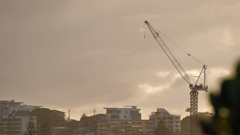 View-across-Coolangatta-and-a-construction-crane-from-Kirra-Hill,-Gold-Coast,-Australia