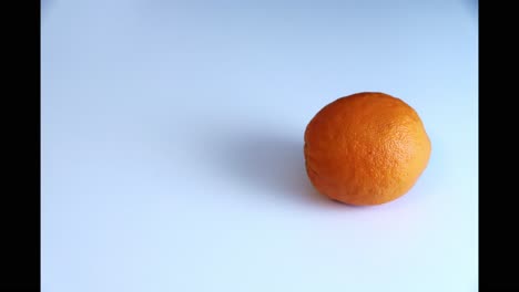 Whole-orange-fruit-doing-circles-in-stop-motion-isolated-on-white-background