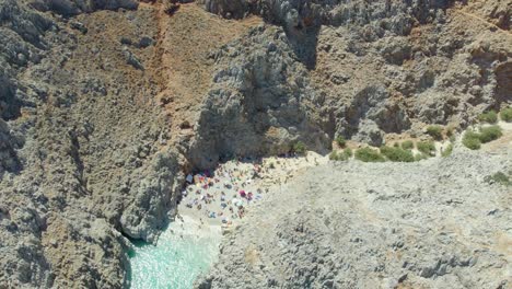 Aerial-Drone-View-Of-Tourists-On-The-Cove-Beach-Of-Seitan-Limania-Near-Chania,-Crete-Island,-Greece