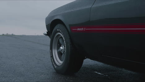 Ford-Mustang-Mach-1-on-Humid-Road-at-Rainy-Day,-Cinematic-Close-Up