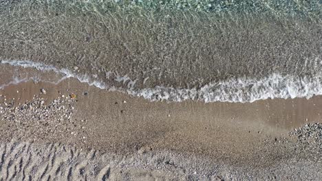 Top-Down-Aerial-View-of-Mediterranean-Sea-Waves-Breaking-on-Sandy-Beach,-High-Angle-Drone-Shot