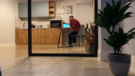 Time-lapse-with-digital-nomad-male-person-working-using-a-laptop-in-kitchen-room