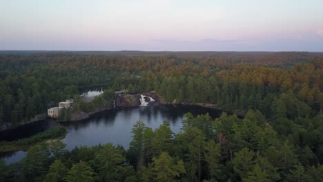 Aerial:-Picturesque-small-roadside-waterfall-in-Muskoka-Lakes,-Canada