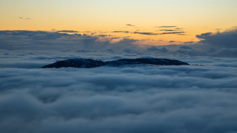 Beautiful-inversion-clouds-immersing-and-dancing-around-two-mountains-in-Bergen,-Norway