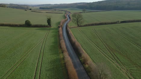 Aerial-drone-shot-of-an-uk-road-in-the-winter-at-sunset
