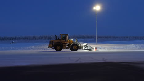 Bulldozer-Clearing-the-Airport,-Snow-Removal-at-Arvidsjaur-in-Sweden