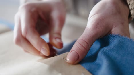 Fashion-designer-working-and-creating-clothes-for-the-new-season,-hands-close-up,-woman-sewing-with-different-fabrics