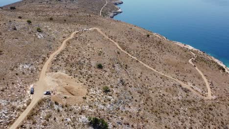 Aerial-view-of-access-road-to-beautiful-beach-on-the-Albanian-coast,-Europe