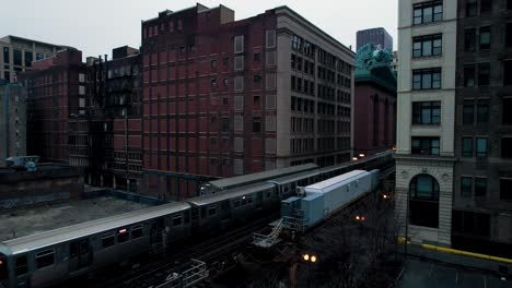 Chicago-Elevated-Subway-Train-Traveling-Through-Downtown-Loop-In-The-Evening-Drone