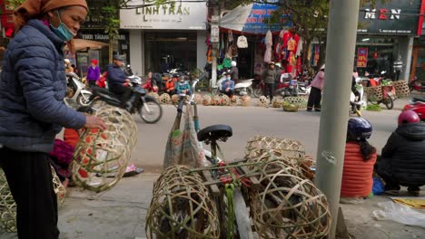 Static-shot-of-woman-loading-up-woven-baskets-onto-her-moped-in-Lang-Son
