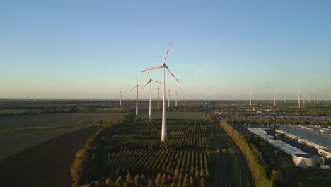 Amazing-aerial-view-flight-panorama-overview-drone
of-a-Wind-farm-wheel-Field-at-Brandenburg-Germany-at-summer-day-evening-2022