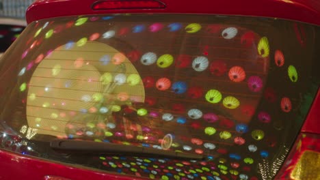 Static-shot-of-the-bright-lanterns-hanging-reflecting-in-a-car-window