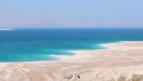 The-Dead-Sea-with-salt-deposits-and-quicksand-along-the-coastline-from-falling-saline-water-levels-in-Jordan-Rift-Valley