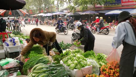Static-shot-of-customers-buying-fresh-produce-from-a-street-market-in-Lang-Son