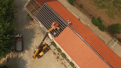 Man-Putting-New-Roof-in-Old-Building-Aerial-View