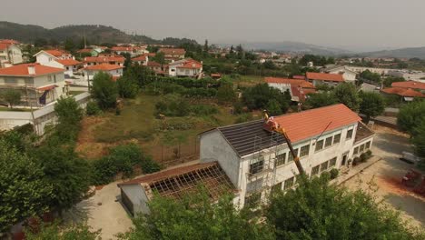 Workers-Putting-New-Roof-in-Old-Building-Construction-Aerial-View