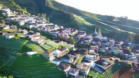 Aerial-view-of-beautiful-village-and-plantation-on-the-slope-of-mountain-in-the-morning