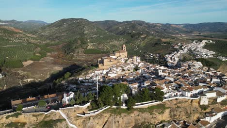 Iznajar-white-mountain-village-and-castle-in-Andalusia,-Spain---Aerial-4k