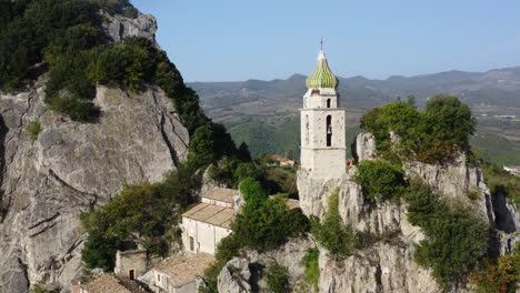 Tight-aerial-orbit-around-romanesque-church-of-San-Silvestro-in-Bagnoli-del-Trigno-in-Molise-region-in-Italy,-4K