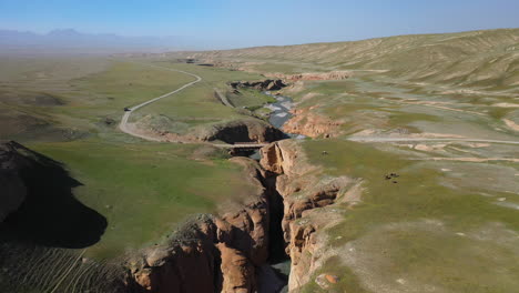 Aerial-drone-shot-descending-into-a-crevasse-near-the-Kel-Suu-lake-in-Kyrgyzstan