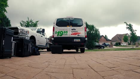 timelapse-of-a-filming-crew-about-to-load-gear-into-a-uhaul-van-on-a-clody-day---low-angle