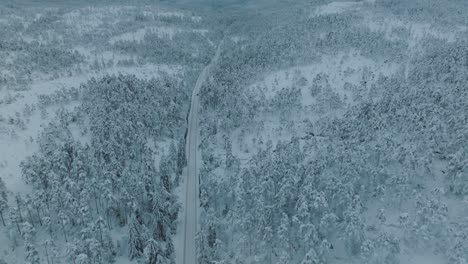 Drone-shot-of-EV-Opel-Ampera-driving-in-beautiful-big-snowy-landscape-in-Norway