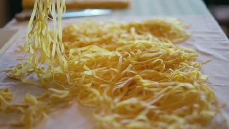 Close-up-shot-of-an-Italian-chef-moving-Italian-handmade-pasta-over-a-white-cloth
