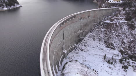 Aerial-view-of-the-Lake-and-Dam-from-Valea-Draganului-in-Winter-time-around-Transylvania,-Romania
