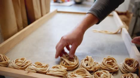 close-up-panning-shot-of-an-Italian-artisan-making-handmade-pasta-full-of-flour