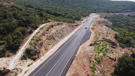 Aerial-view-of-cars-driving-on-a-new-mountain-road-in-Albania