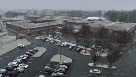 Snowflakes-falling-on-American-high-school-and-parking-lot