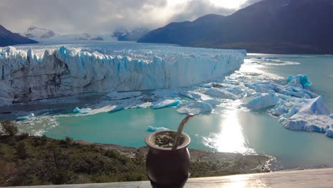 Yerba-mate-crowned-by-a-turquoise-river,-a-glacier,-an-imposing-mountain-and-a-majestic-sky,-Argentina