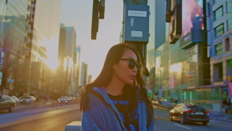 beautiful-Asian-oriental-female-girl-woman-model-in-big-city-town-urban-street-area-with-sunglasses-acting-and-playing