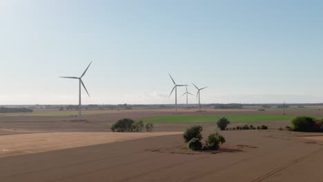 Wind-turbines-and-Swedish-countryside-on-sunny-summer-day-in-in-a-drone-descent-scene