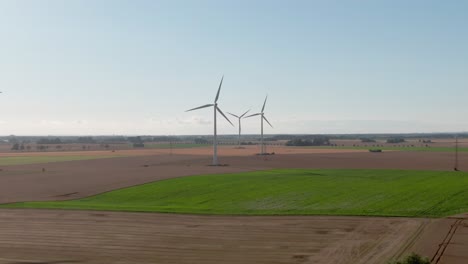 Soft-aerial-pull-out-shot-of-wind-turbines-in-European-rural-area