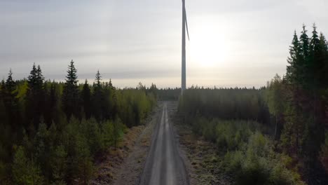 Reveal-shot-of-an-isolated-wind-turbine-in-the-middle-of-the-woods,-cinematic
