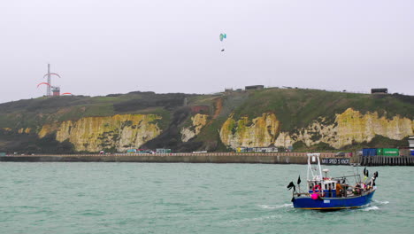 Paragliding-at-Newhaven-when-fishing-boat-returning-to-docks