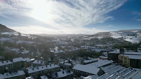 Snowy-winter-Cinematic-aerial-view-cityscape-townscape-with-snow-covered-roof-tops-Panorama-4K-Marsden-Village-West-Yorkshire,-Endland