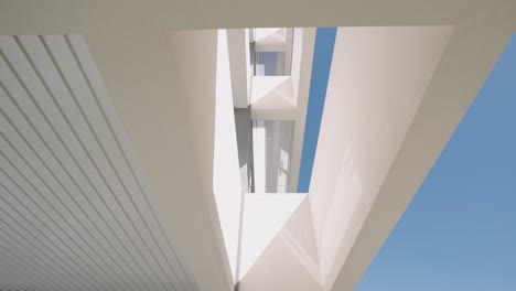 Modern-architecture-geometrical-shapes-white-surface,-sky