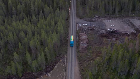 concrete-mixer-truck-and-construction-equipment-in-the-middle-of-a-forest-in-europe,-top-down-view