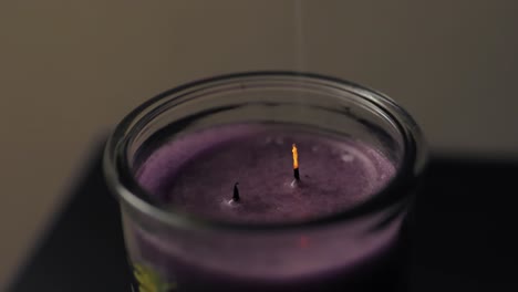 Ember-going-up-with-smoke-from-a-candle-with-two-wicks-two-fires