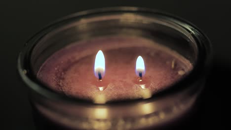 Candle-with-two-wicks-being-lit-two-fires-one-candle