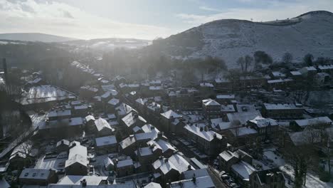 Cold-Snowy-Winter-Cinematic-aerial-view-cityscape-townscape-with-snow-covered-roof-tops-Panorama-4K-Delph-Village-West-Yorkshire,-Endland
