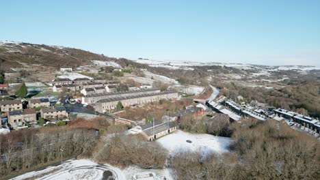 Winter-Cinematic-aerial-view-cityscape-townscape-with-snow-covered-roof-tops-4K-Marsden-Village-West-Yorkshire,-Endland