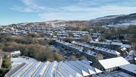 Cold-Snowy-Winter-Cinematic-aerial-view-cityscape-townscape-with-snow-covered-roof-tops-Panorama-4K-footage-of-the-town-of-Marsden-West-Yorkshire,-UK