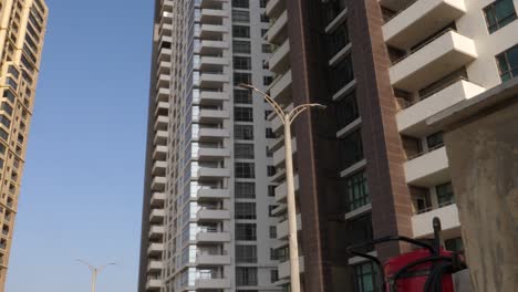 Slow-Dolly-Left-Reveal-Looking-Up-At-Emaar-Residential-Apartments-Located-In-Crescent-Bay,-Karachi
