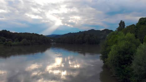 Rising-drone-footage-ober-the-river-Drau-near-Maribor-with-amazing-sunrays-while-sunset