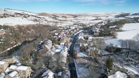Cold-Snowy-Winter-Cinematic-aerial-view-cityscape-townscape-with-snow-covered-roof-tops-4K-Delph-Village-West-Yorkshire,-Endland