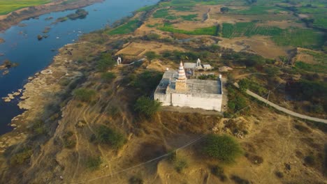 Aerial-drone-shot-of-a-Hindu-temple-on-a-River-in-Morena-,-India