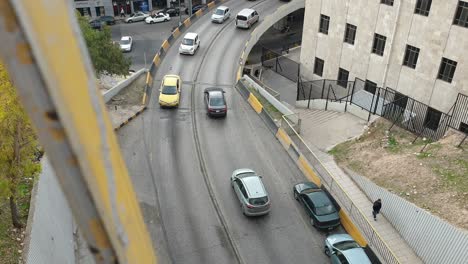Birds-eye-view-of-flowing-traffic-commuting-to-work-over-bridge-in-capital-city-of-Amman-in-Jordan,-Middle-East